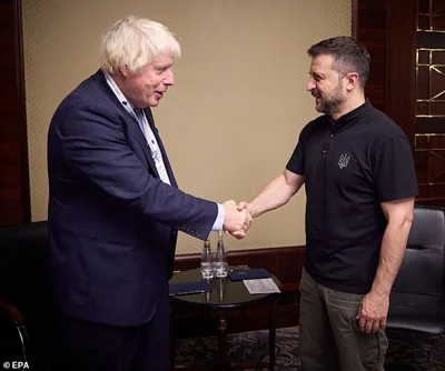 Volodymyr Zelensky shakes hands with Boris Johnson during a meeting in Kyiv, 13 September