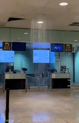 Water is seen pouring from the ceiling of the El Prat airport, where flights have been diverted amid the deluge