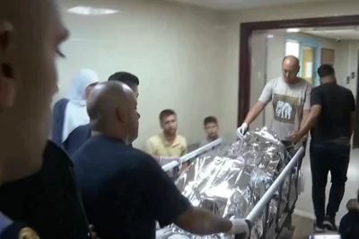 This image taken from an Associated Press video shows Aysenur Ezgi Eygi's body being transported through the Rafidia Surgical Hospital, where she was taken after after witnesses say she was fatally shot by Israeli soldiers, Sept. 6, in the West Bank city of Nablus. AP-Yonhap