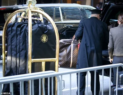 A mass of Louis Vuitton luggage and Presidential emblem on 6 Suit clothing covers were loaded into a support vehicle before leaving in a motorcade of 10 vehicles