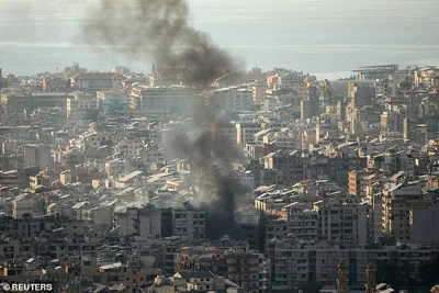 Smoke rises over Beirut's southern suburbs after Israeli air strikes on October 12