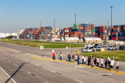 HOUSTON, TEXAS - OCTOBER 01: In an aerial view, dockworkers strike outside of the Port of Houston Authority on October 01, 2024 in Houston, Texas. Members of the International Longshoreman's Association have begun a nationwide strike, consisting of more than 50,000 workers at ports along the East Coast and Texas. The strike, affecting 36 ports, marks a historic event and is the first by the union since 1977. The strike comes after negotiations between the International Longshoreman's Association and the United States Maritime Alliance failed to reach an agreement on better wages and automation. Brandon Bell/Getty Images/AFP (Photo by Brandon Bell / GETTY IMAGES NORTH AMERICA / Getty Images via AFP)