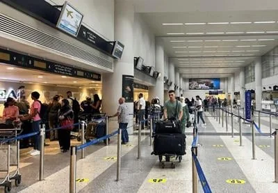 Passengers wait near check-in desks inside Beirut-Rafic Al Hariri International Airport, in Beirut